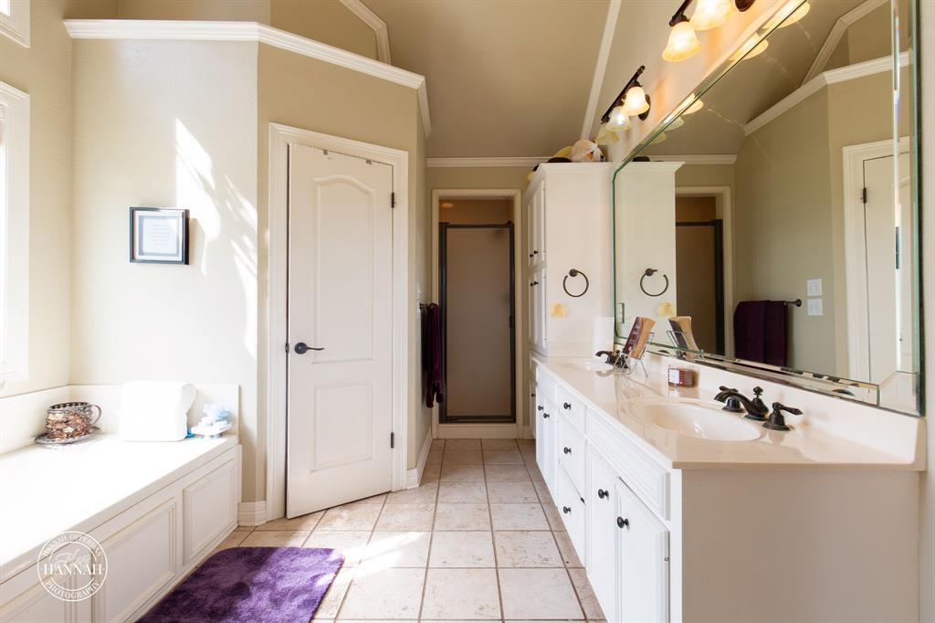 6531 North Liberty Way Keithville, LA 71047 - Photo 15 of 28 a spacious bathroom with a double vanity sink mirror and bathtub