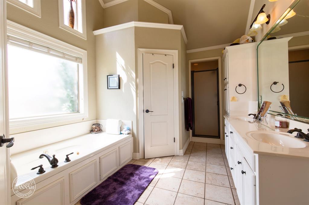 6531 North Liberty Way Keithville, LA 71047 - Photo 16 of 28 a spacious bathroom with a tub sink and mirror