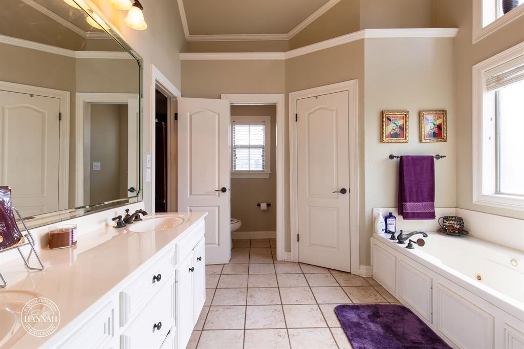 6531 North Liberty Way Keithville, LA 71047 - Photo 17 of 28 a bathroom with a double vanity sink a mirror and a bathtub