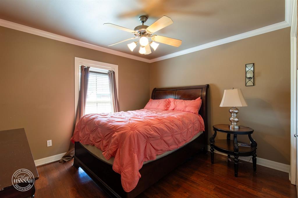 6531 North Liberty Way Keithville, LA 71047 - Photo 19 of 28 a bedroom with a bed and a chandelier