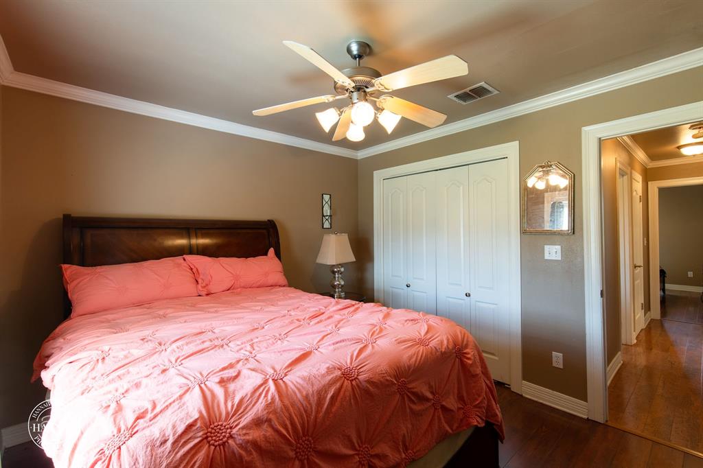 6531 North Liberty Way Keithville, LA 71047 - Photo 20 of 28 a bedroom with a bed and a chandelier