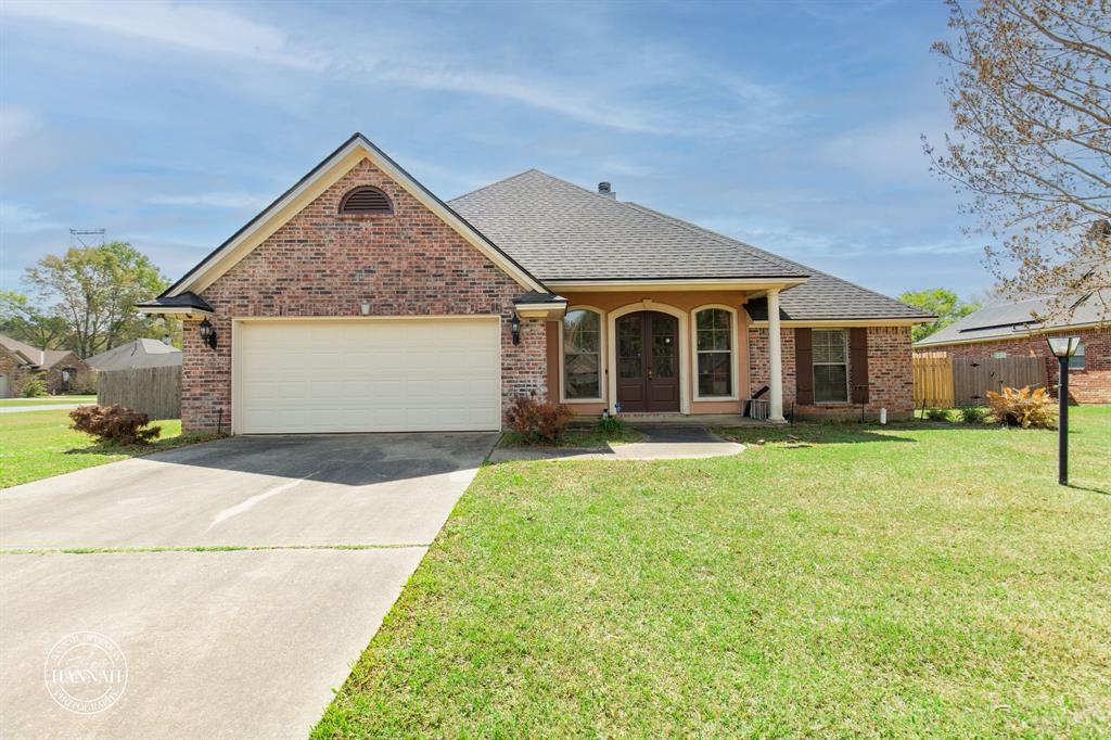 6531 North Liberty Way Keithville, LA 71047 - Photo 2 of 28 a front view of a house with a garden and porch
