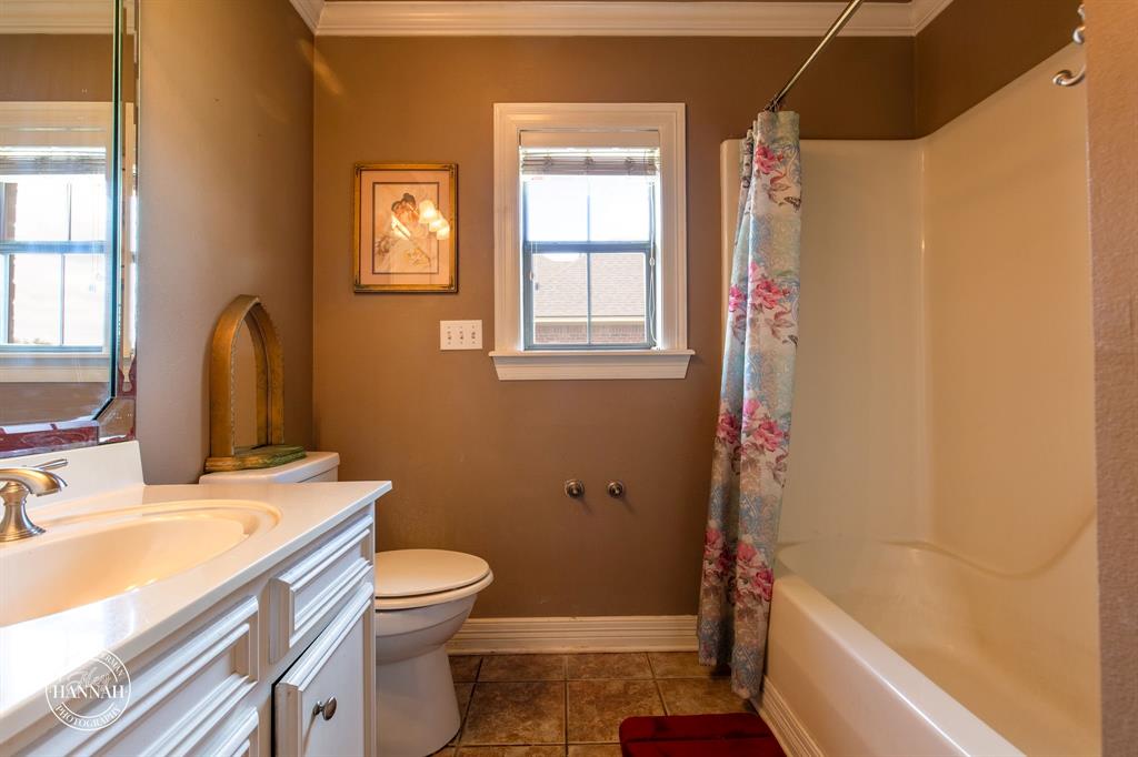 6531 North Liberty Way Keithville, LA 71047 - Photo 21 of 28 a bathroom with a sink a toilet and shower