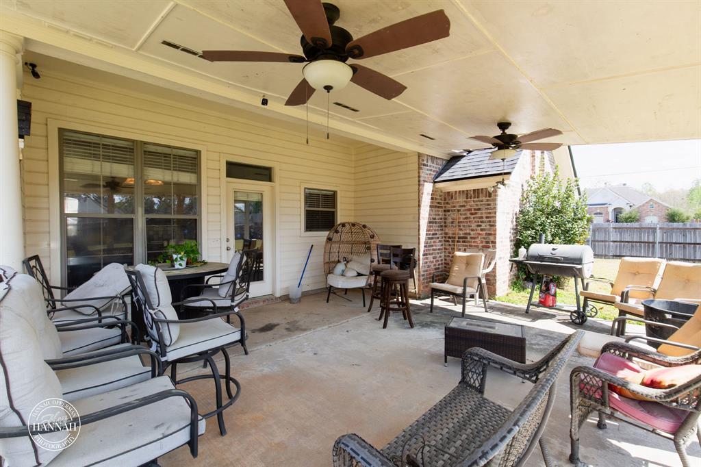 6531 North Liberty Way Keithville, LA 71047 - Photo 24 of 28 a living room with furniture a fireplace and a table