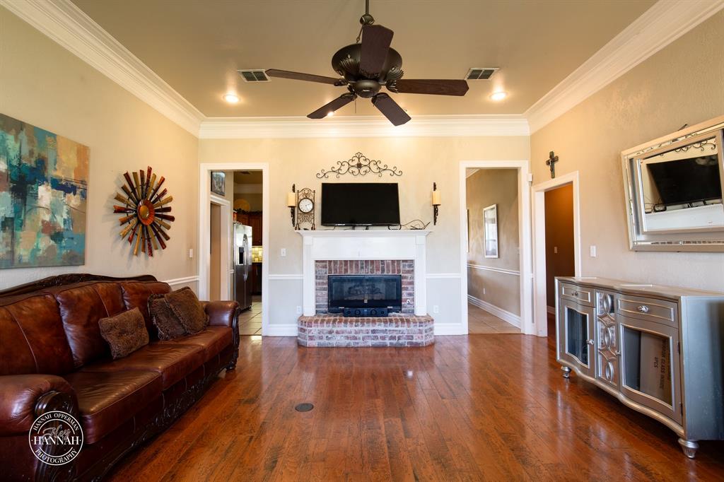 6531 North Liberty Way Keithville, LA 71047 - Photo 5 of 28 a living room with furniture a fireplace and a flat screen tv