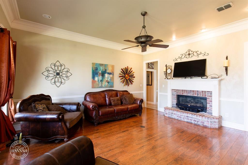 6531 North Liberty Way Keithville, LA 71047 - Photo 7 of 28 a living room with furniture a flat screen tv and a fireplace