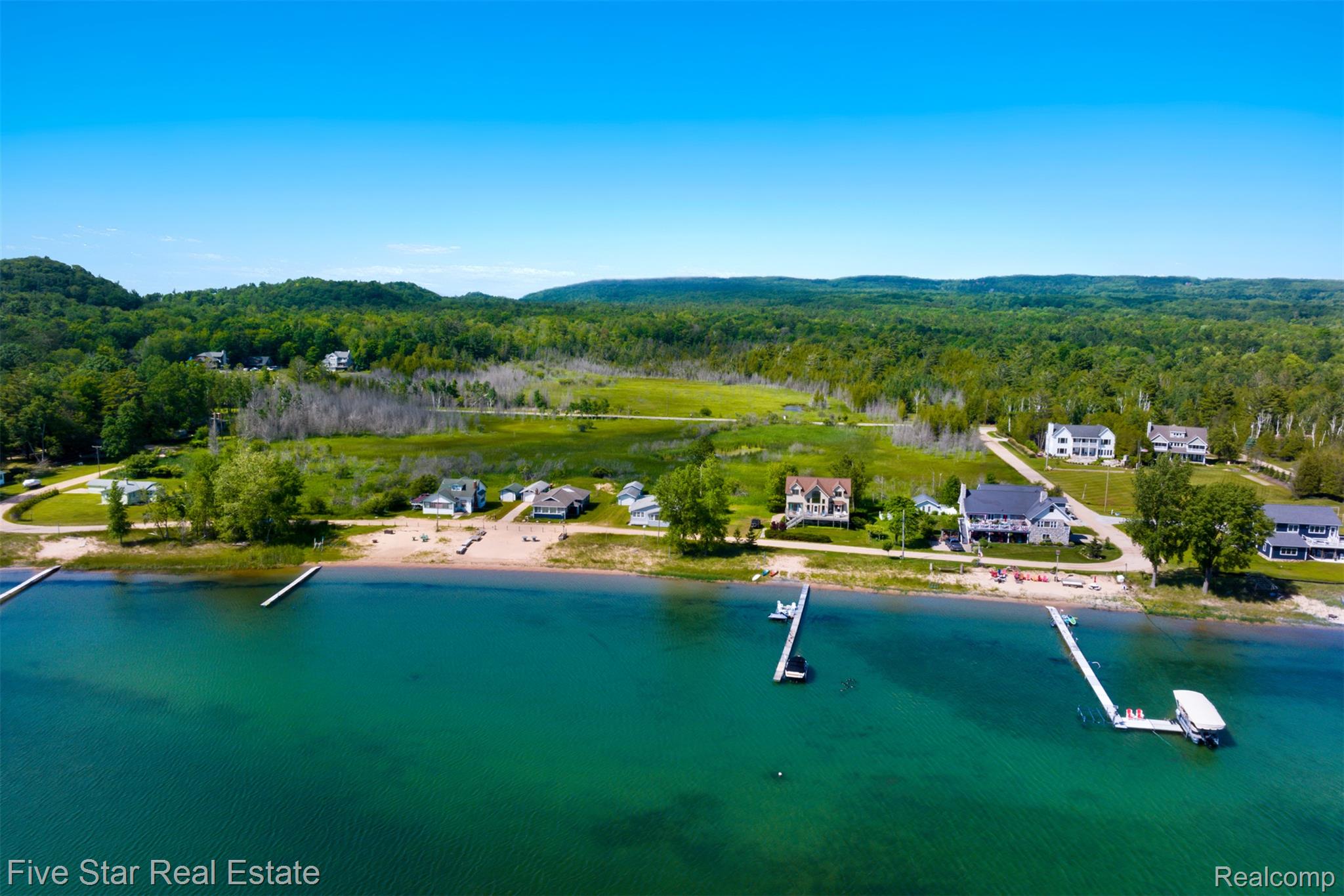 2588 Lakeview Road Onekama, MI 49675 - Photo 29 of 32 Aerial perspective showcasing a waterfront property with a sandy shoreline
