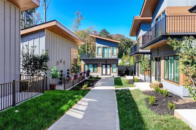 an aerial view of residential houses with yard