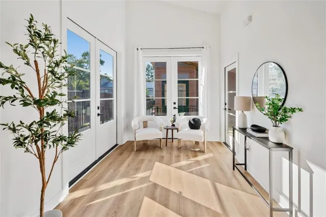 a living room with furniture and a painting on the wall