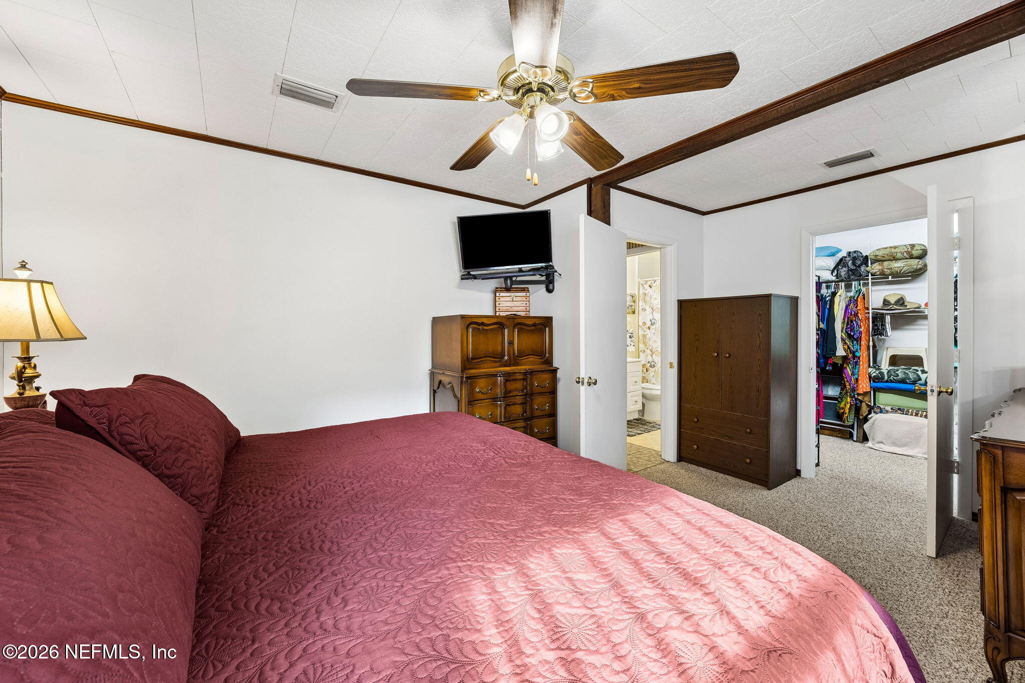 110 Shaffer Avenue Crescent City, FL 32112 - Photo 13 of 44 a bedroom with a bed and a flat tv screen on dresser