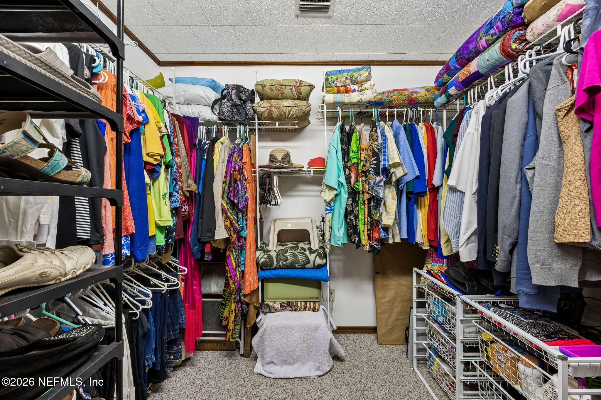 110 Shaffer Avenue Crescent City, FL 32112 - Photo 14 of 44 a view of walk in closet with clothes and shoes