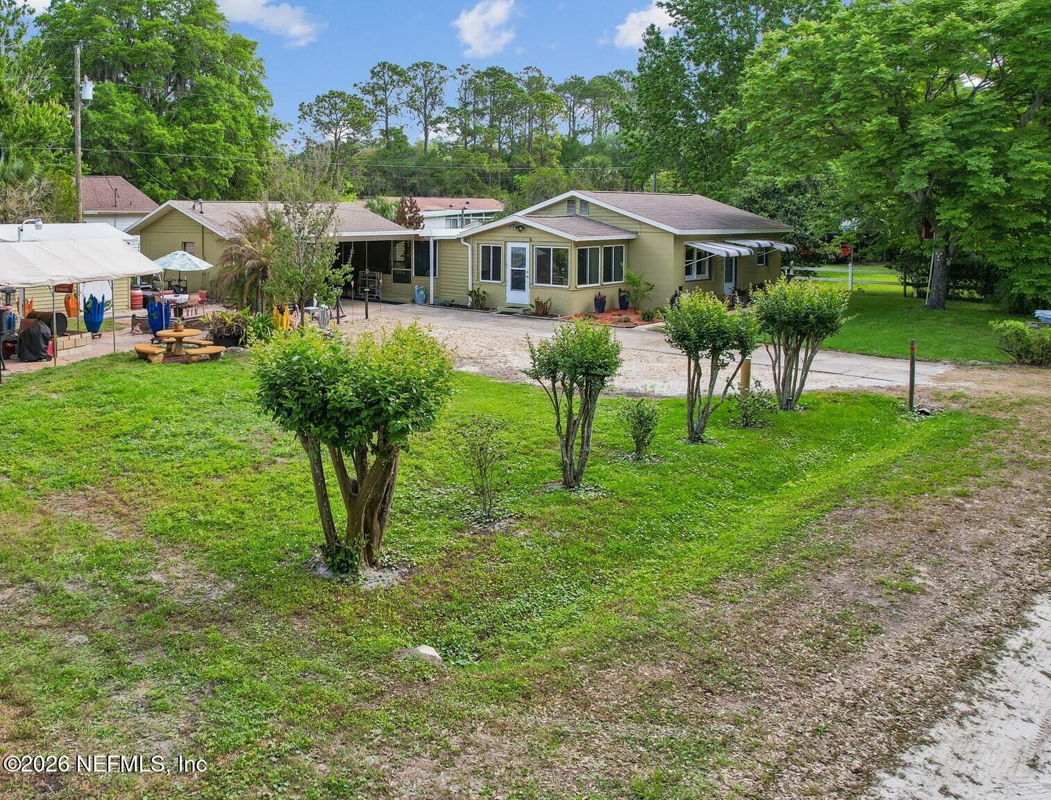 110 Shaffer Avenue Crescent City, FL 32112 - Photo 2 of 44 a front view of a house with a yard table and chairs