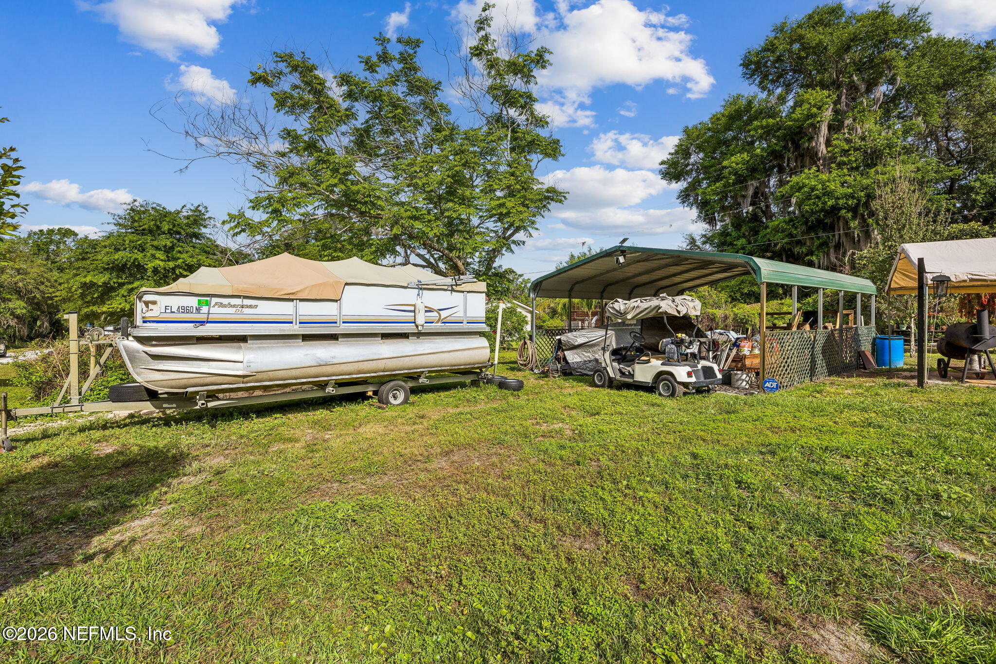 110 Shaffer Avenue Crescent City, FL 32112 - Photo 27 of 44 a backyard of a house with barbeque oven table and chairs