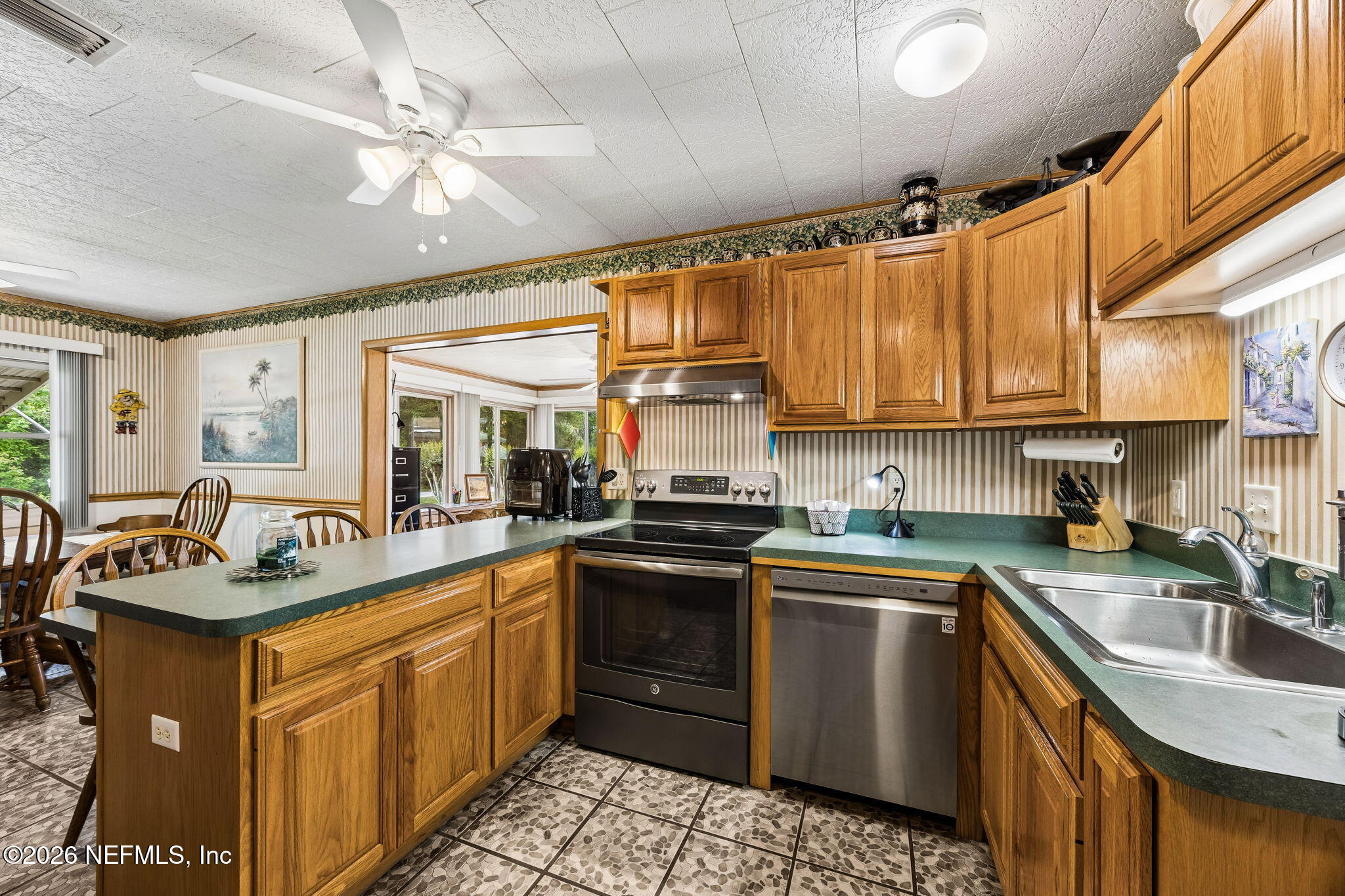 110 Shaffer Avenue Crescent City, FL 32112 - Photo 7 of 44 a kitchen with stainless steel appliances granite countertop a sink a stove and cabinets