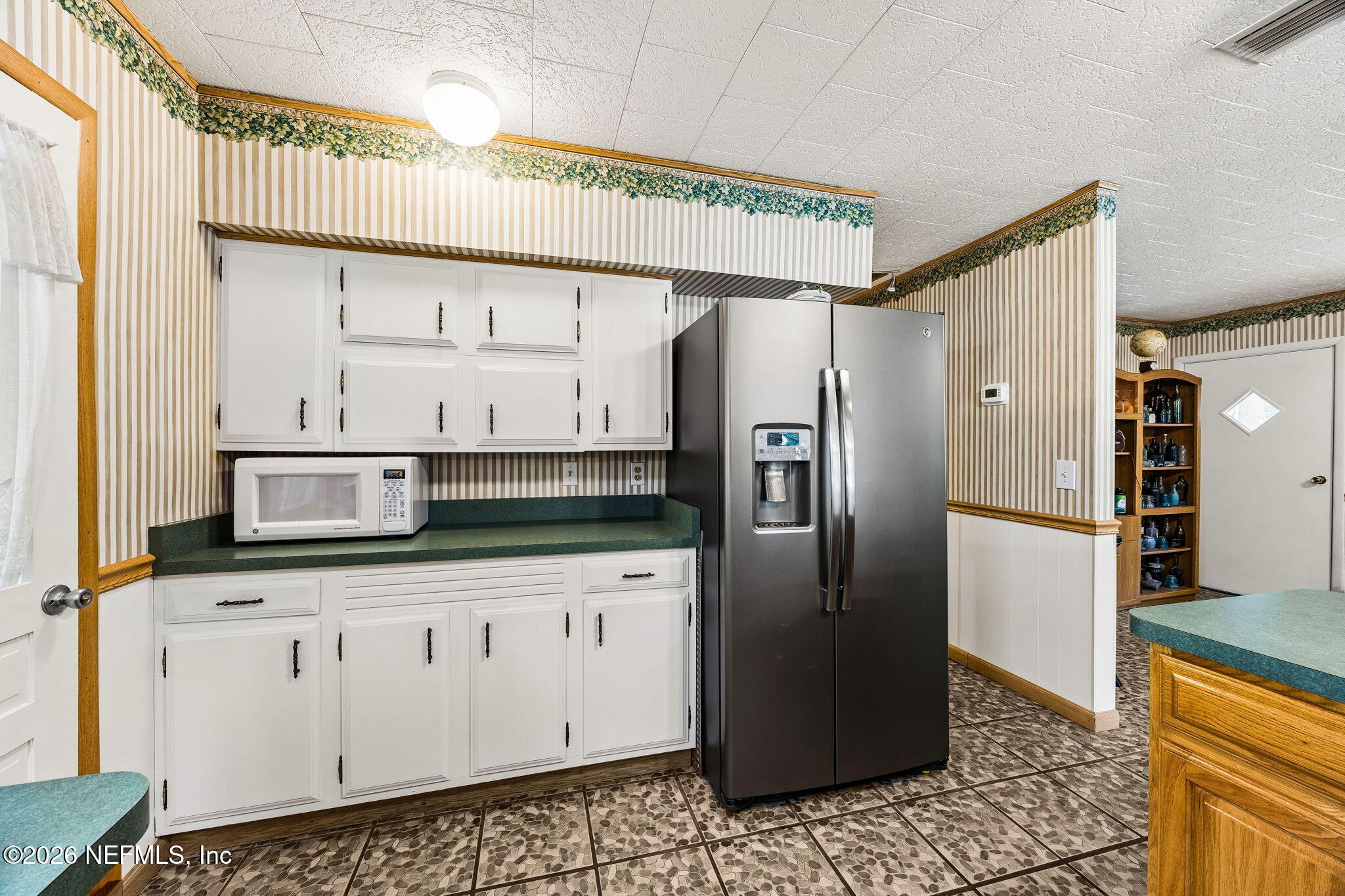 110 Shaffer Avenue Crescent City, FL 32112 - Photo 9 of 44 a kitchen with stainless steel appliances granite countertop a refrigerator and a sink