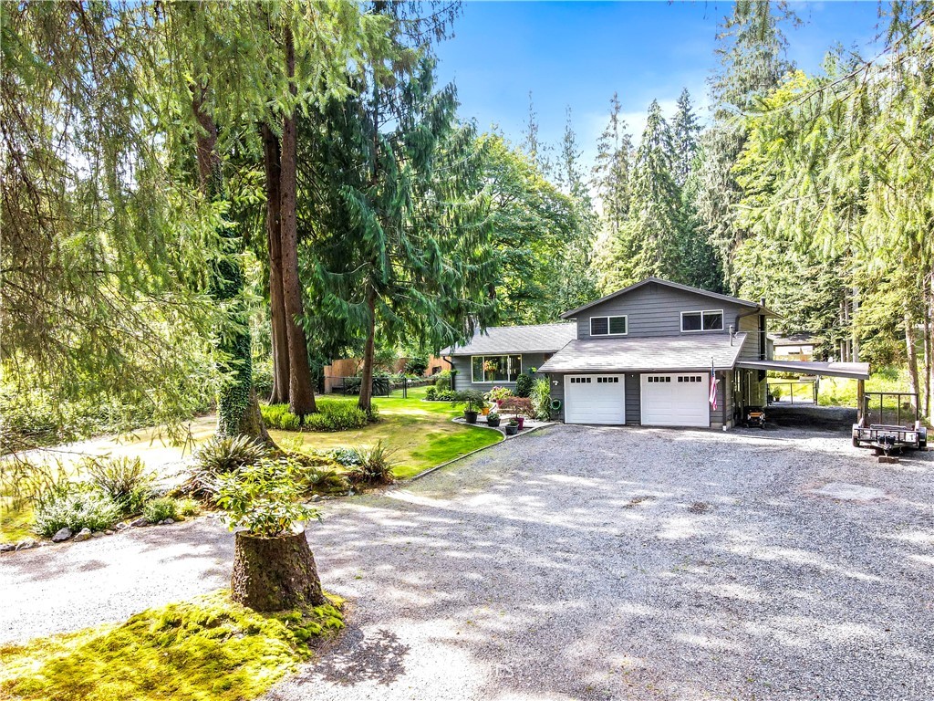 6218 Robe Menzel Road Granite Falls, WA 98252 - Photo 3 of 37 a front view of a house with a yard and trees