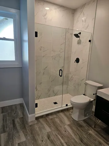 a bathroom with a toilet and a shower