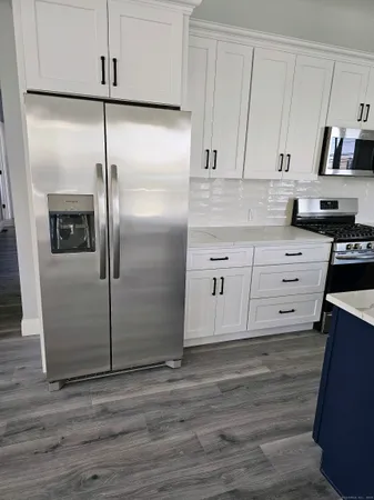a kitchen with stainless steel appliances a refrigerator and a stove