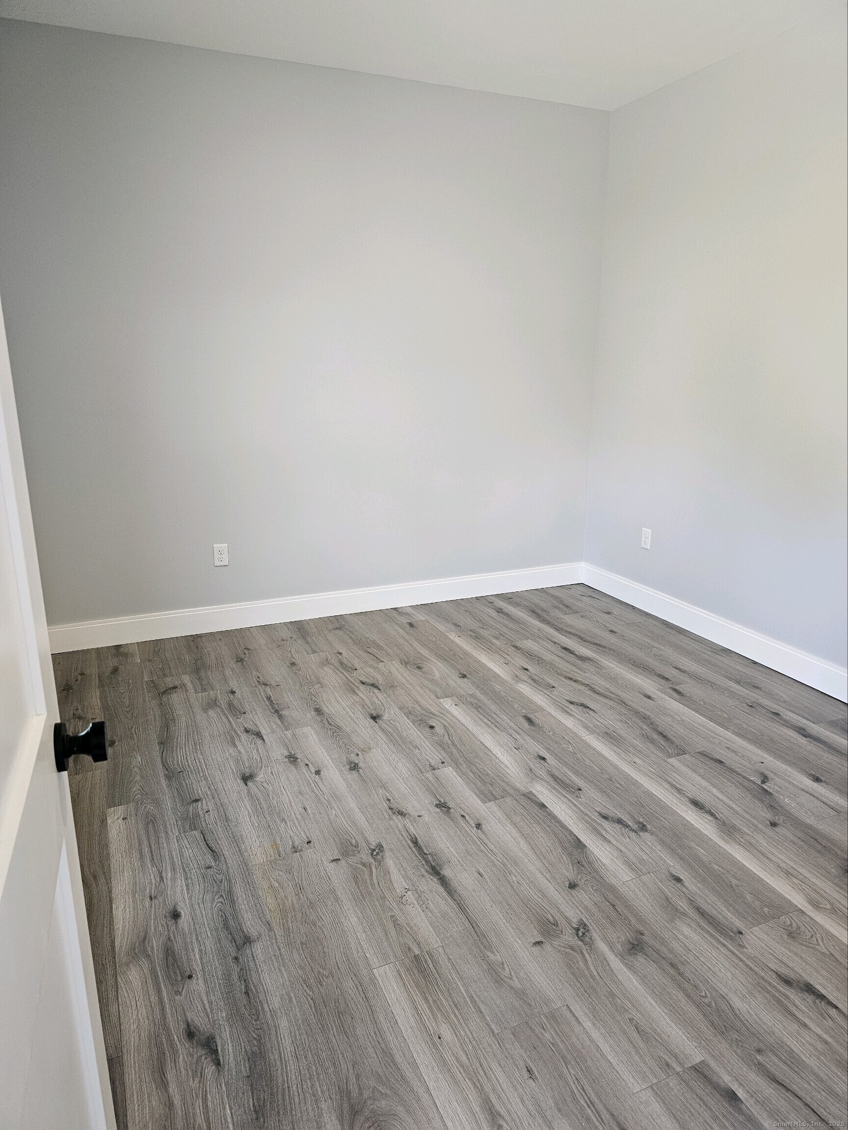 281 Pequot Avenue, Unit 2 New London, CT 06320 - Photo 4 of 21 an empty room with wooden floor