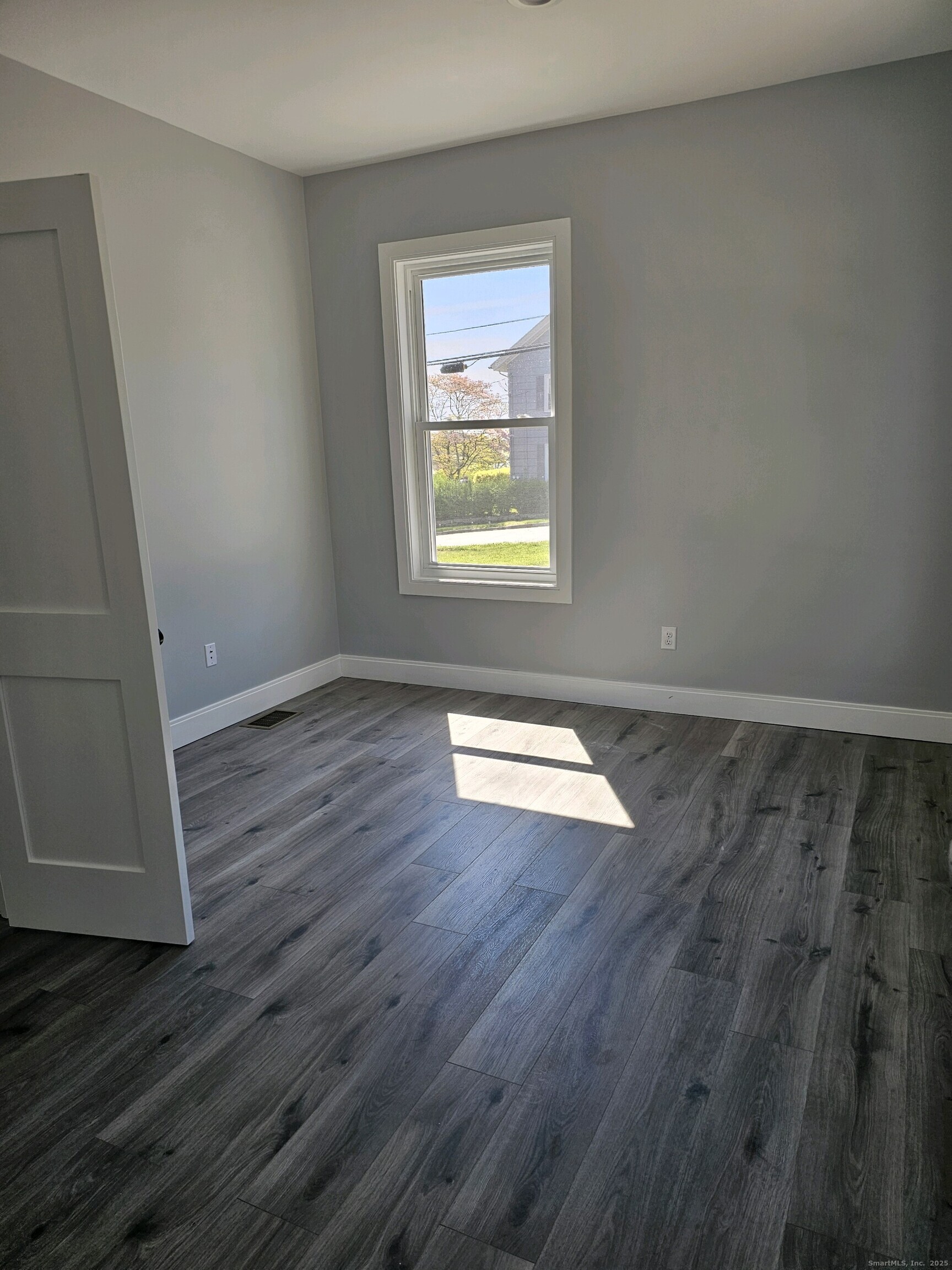 281 Pequot Avenue, Unit 2 New London, CT 06320 - Photo 5 of 21 an empty room with wooden floor and windows