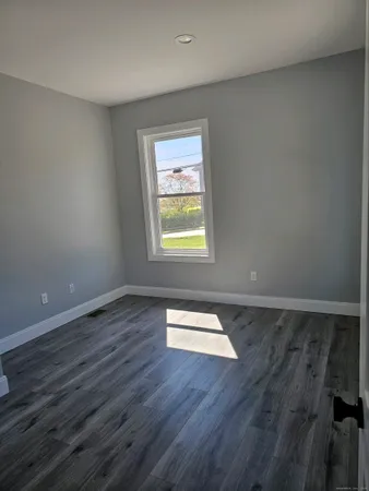 a view of wooden floor and windows in a room