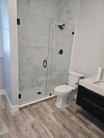 a bathroom with a toilet a sink and a shower