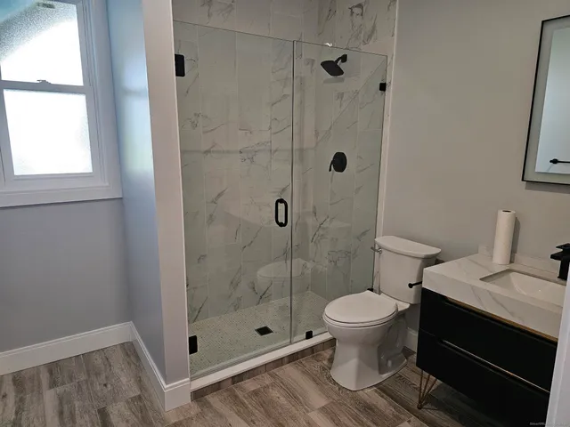 a bathroom with a toilet and a shower