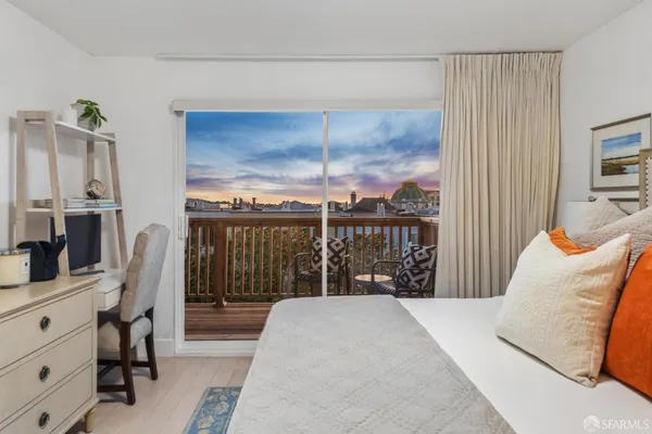 a bedroom with a bed and large window