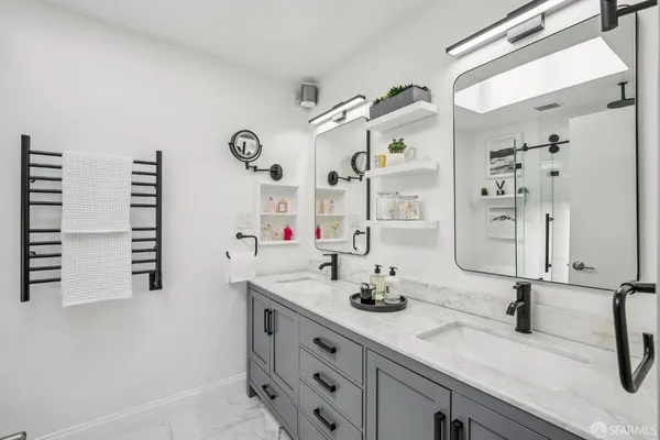 a bathroom with a double vanity sink and a mirror