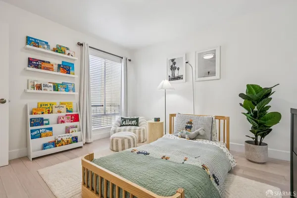 a bedroom with furniture and a potted plant