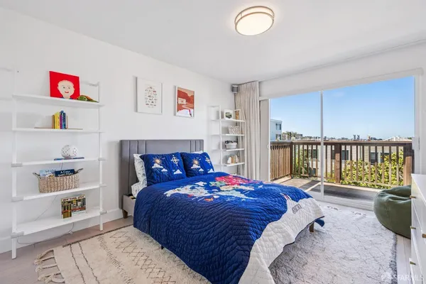 a bedroom with a bed and a large window