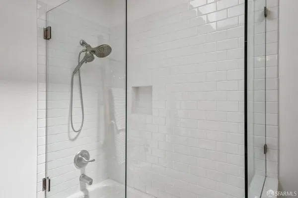a bathroom with a glass shower door