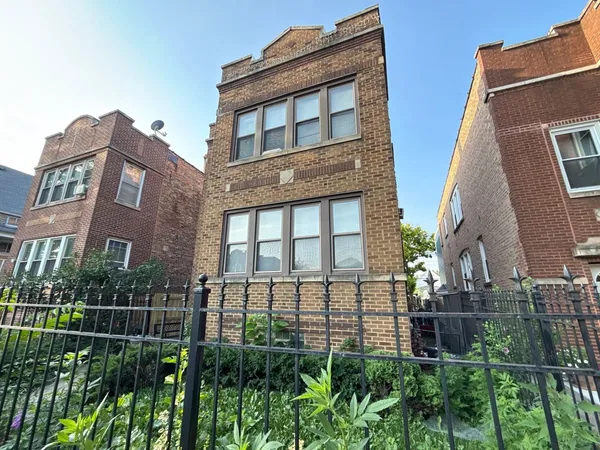 a view of a brick building next to a yard