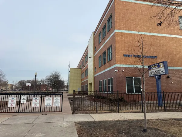 a front view of a building with iron fence