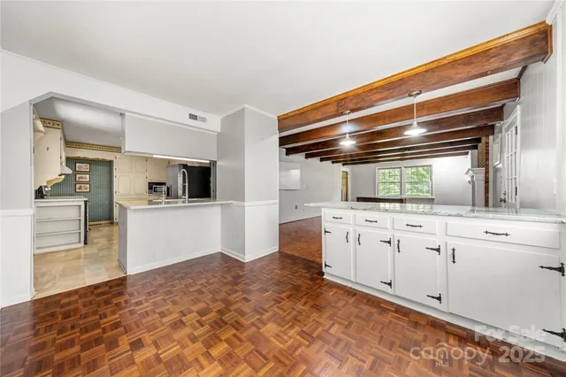 a kitchen with granite countertop a sink and cabinets