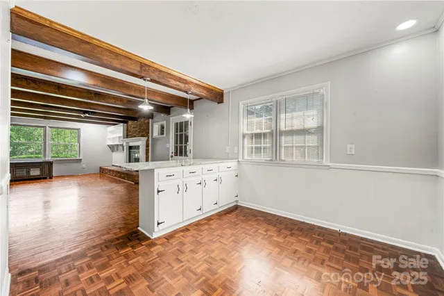 a view of a kitchen with furniture and windows