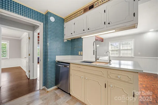 a kitchen with granite countertop white cabinets and sink