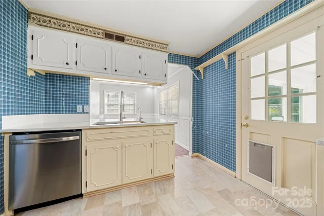 a kitchen with granite countertop white cabinets and white appliances