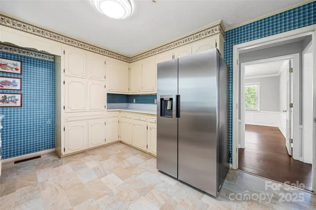 a kitchen with a refrigerator sink and cabinets