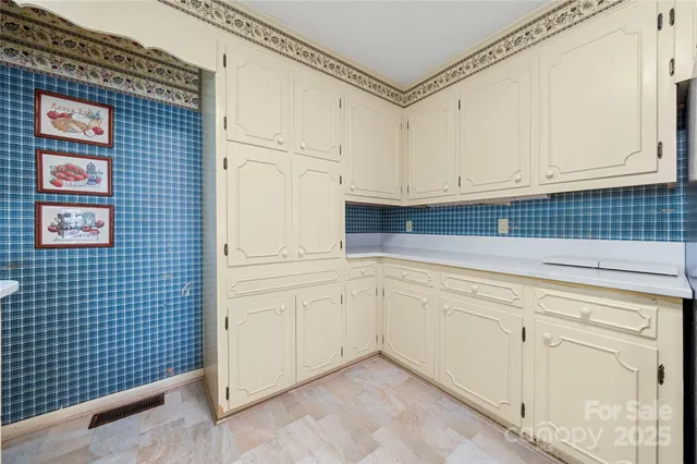 a kitchen with white cabinets and white appliances