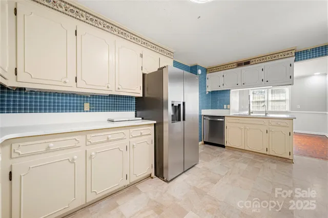 a kitchen with white cabinets and white appliances