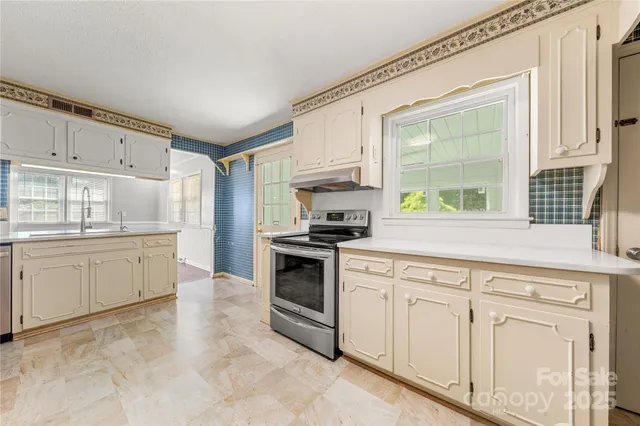a kitchen with white cabinets and white appliances