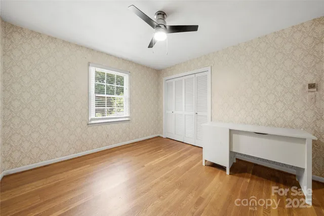 a view of room with window and ceiling fan