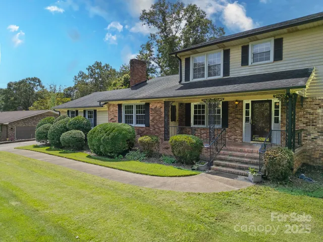 a front view of a house with yard and green space