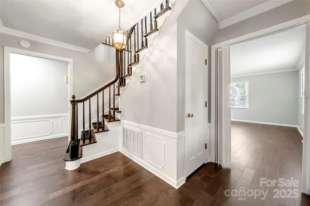 a view of entryway with wooden floor and stairs