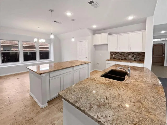 a kitchen with a stove and a sink