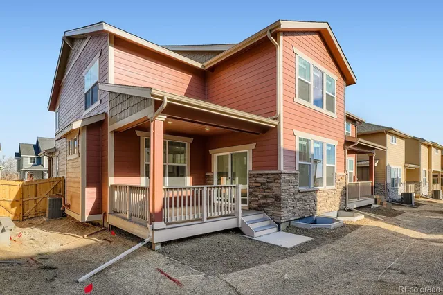 a view of a house with a yard and floor to ceiling window