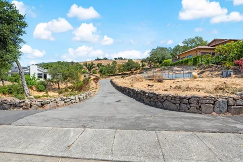 a view of a yard with yellow lighting