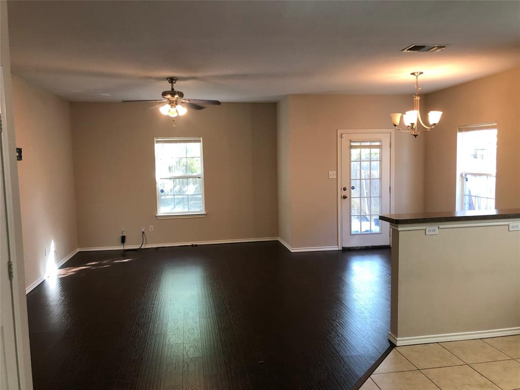 a view of a livingroom with hardwood floor and a ceiling fan