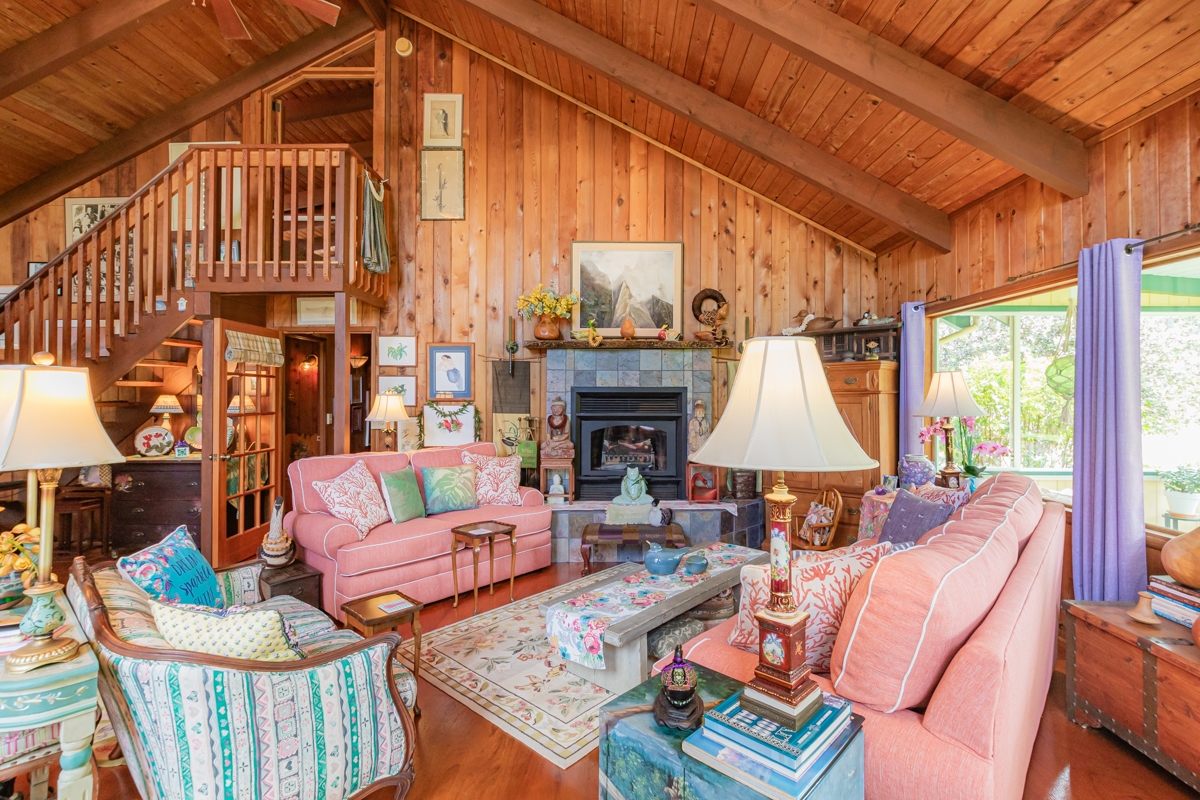 99-1798 Painiu Loop Volcano, HI 96785 - Photo 21 of 29 a living room with furniture a fireplace and a large window